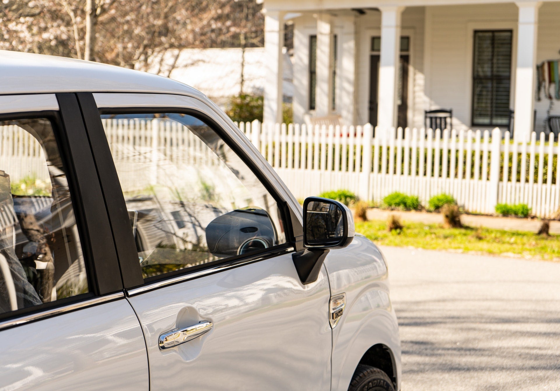 A White Wink Mark3 parked in front of a house.