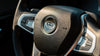 A close up of the Wink logo on a steeringwheel.